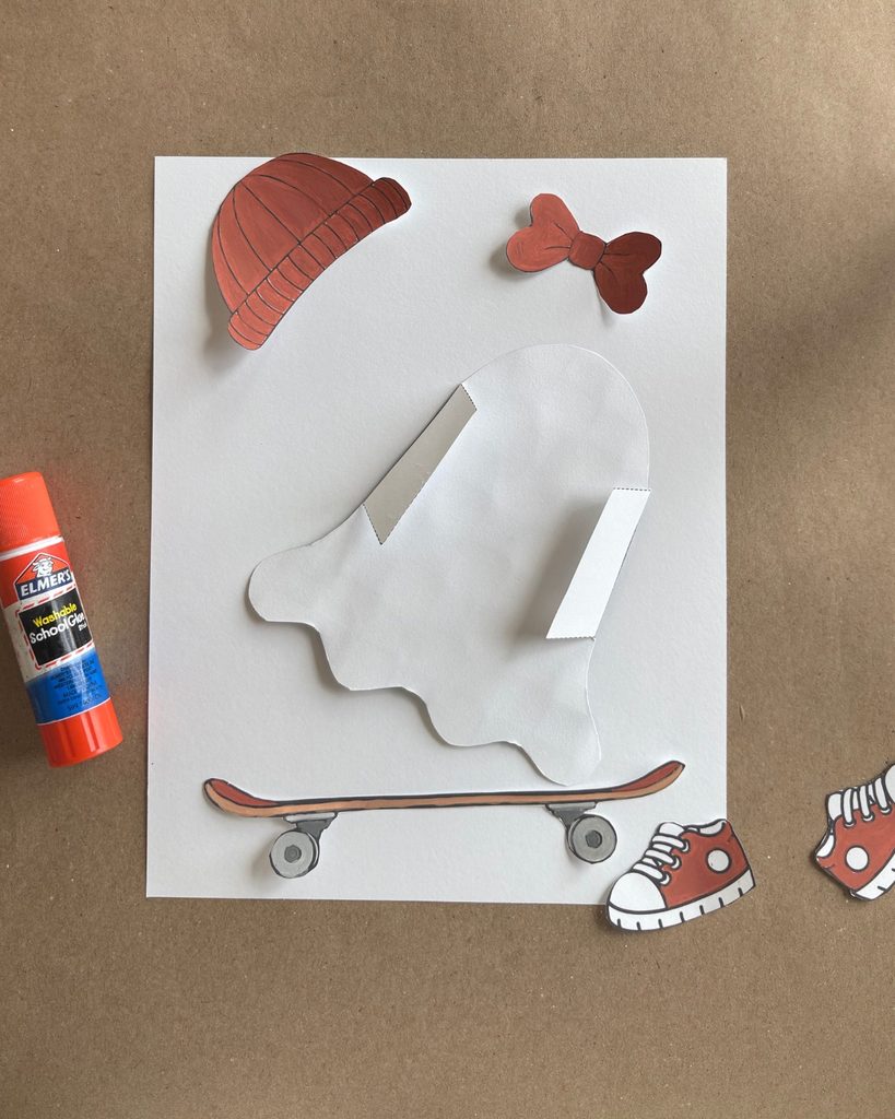 Back of a 3D paper ghost craft showing folded tabs glued to the background to create a curved, pop-out effect.