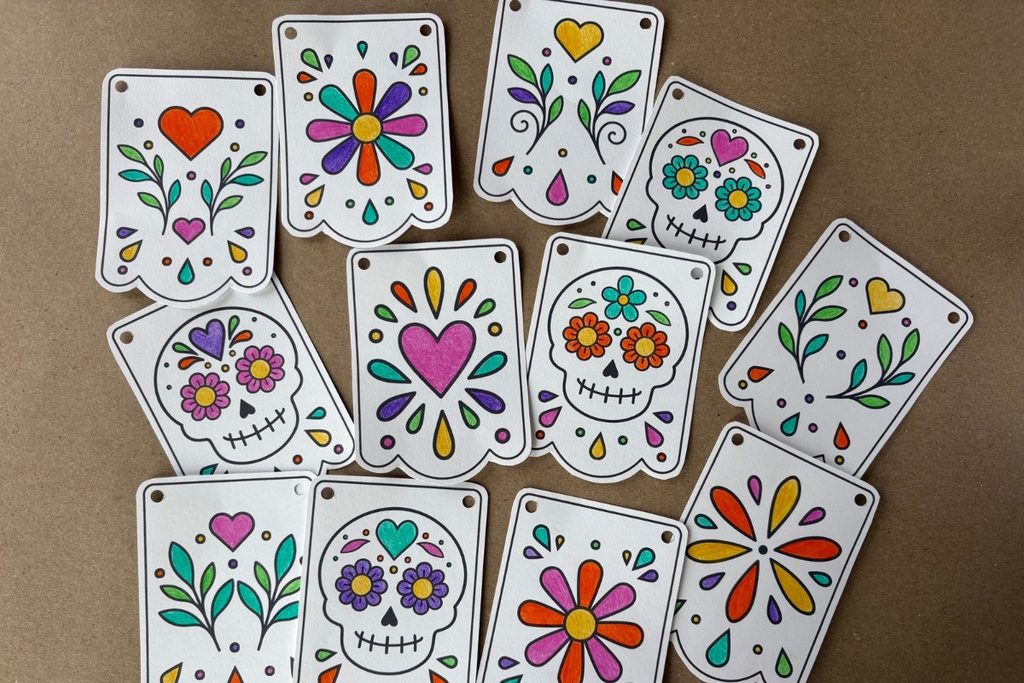 Hand-colored Día de los Muertos banner pieces decorated with bright colors